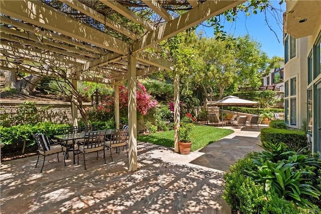 view of patio / terrace featuring fence, a pergola, and outdoor dining space