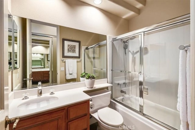 bathroom with toilet, shower / bath combination with glass door, and vanity