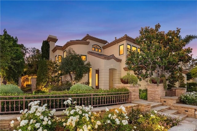 mediterranean / spanish house featuring a chimney