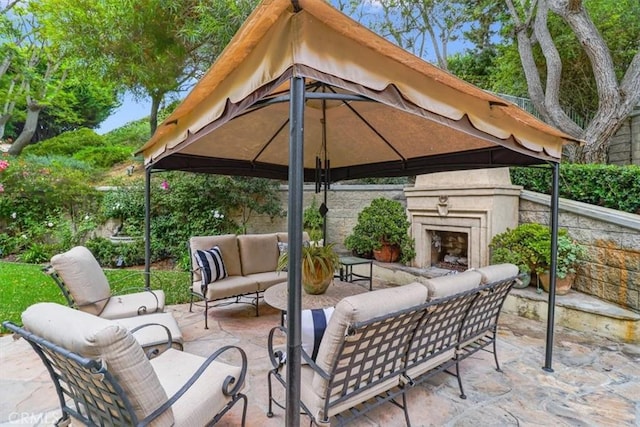 view of patio / terrace with a gazebo and an outdoor living space with a fireplace