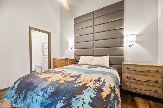 bedroom featuring dark wood-type flooring and ensuite bathroom