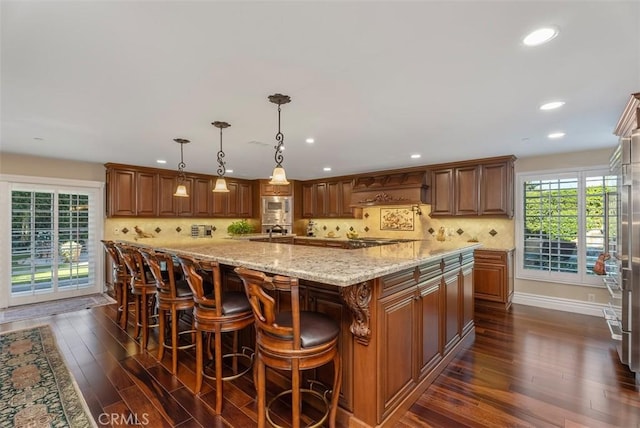 5571 Clover Hill Dr, Yorba Linda, CA 92886 - kitchen featuring dark wood-style flooring, light stone countertops, recessed lighting, and stainless steel microwave