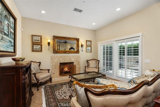 5571 Clover Hill Dr, Yorba Linda, CA 92886 - living area featuring recessed lighting, carpet flooring, visible vents, and a high end fireplace