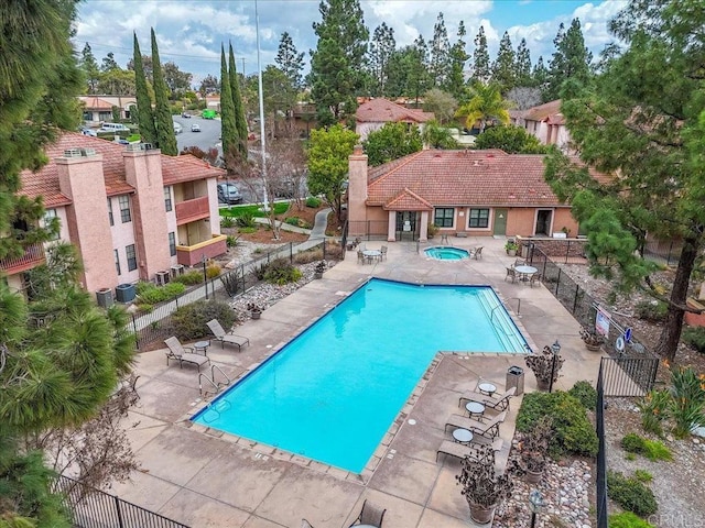 view of pool with a community hot tub and a patio area