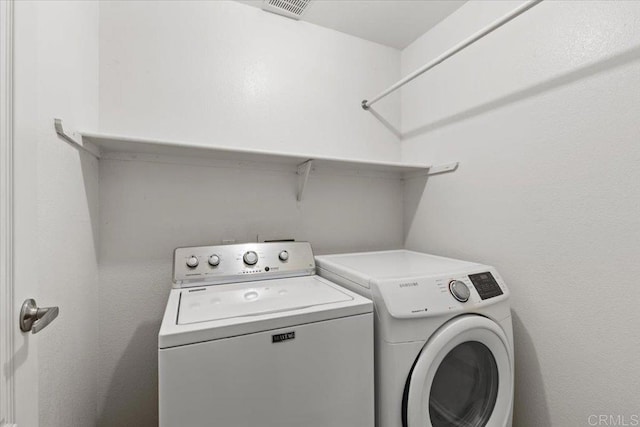 clothes washing area featuring washing machine and clothes dryer