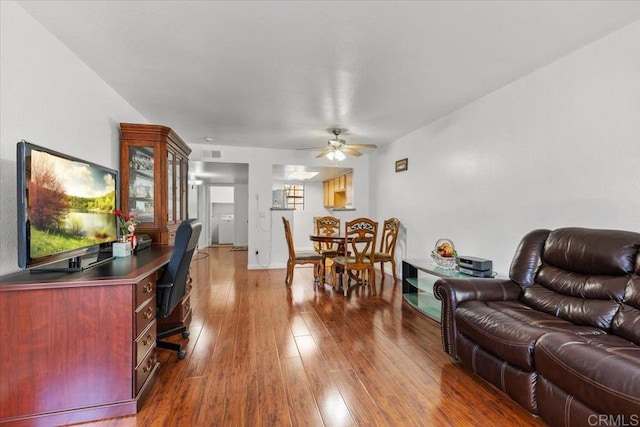 living room featuring ceiling fan and wood-type flooring