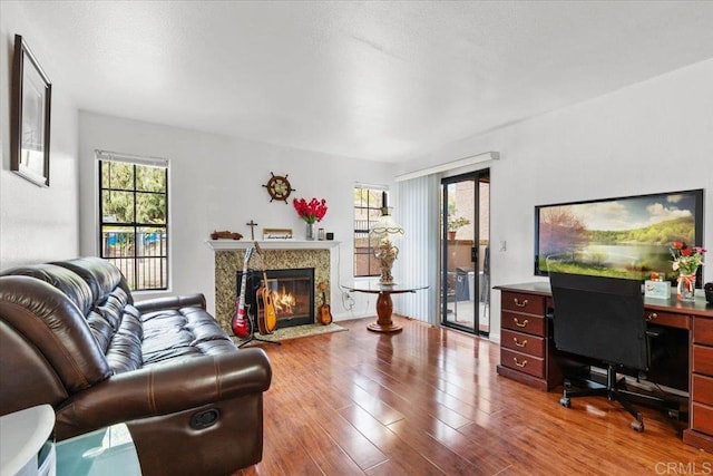 12059 Alta Carmel Ct Unit 167, San Diego, CA 92128 - living room with wood finished floors, a high end fireplace, and an office area