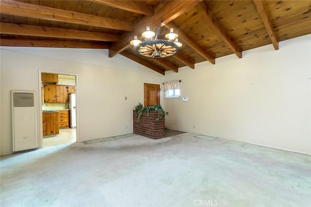 empty room featuring lofted ceiling with beams, an inviting chandelier, light colored carpet, and wooden ceiling