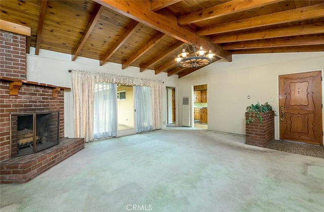 unfurnished living room with vaulted ceiling with beams, a notable chandelier, wood ceiling, carpet floors, and a brick fireplace