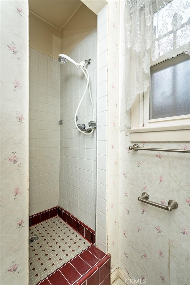 bathroom with a tile shower