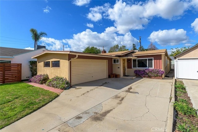 single story home featuring a garage and a front yard