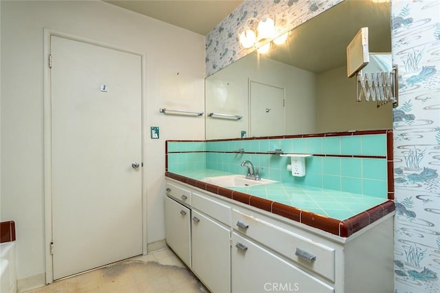 bathroom with vanity and tasteful backsplash