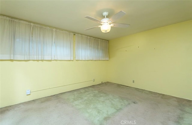 unfurnished room with ceiling fan and carpet flooring