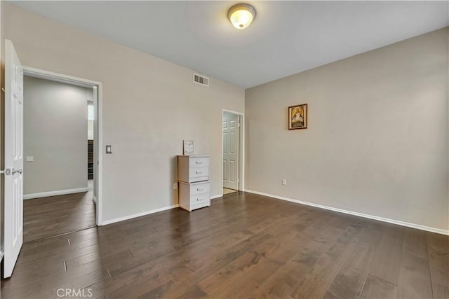 unfurnished bedroom with dark hardwood / wood-style flooring