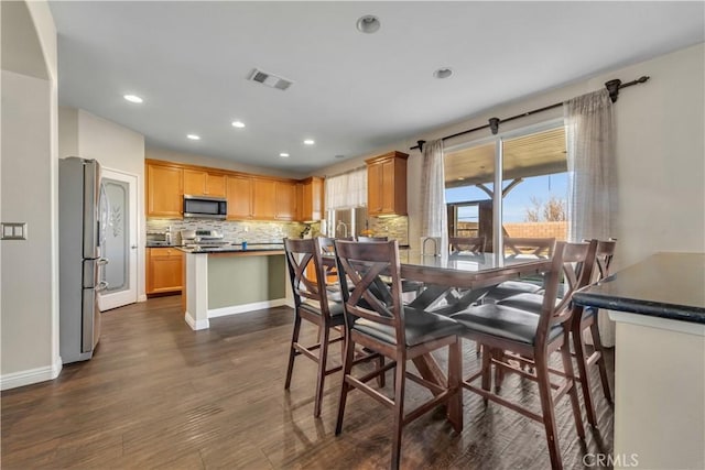 dining space featuring dark hardwood / wood-style flooring