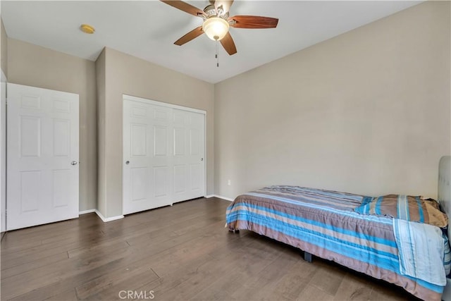 bedroom with ceiling fan and dark wood-type flooring