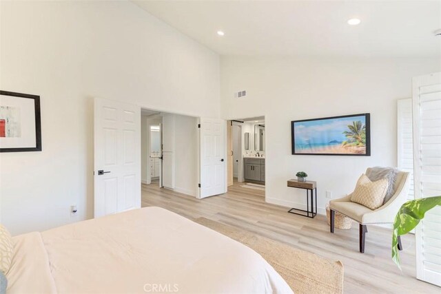 bedroom with light wood-type flooring, visible vents, high vaulted ceiling, and recessed lighting