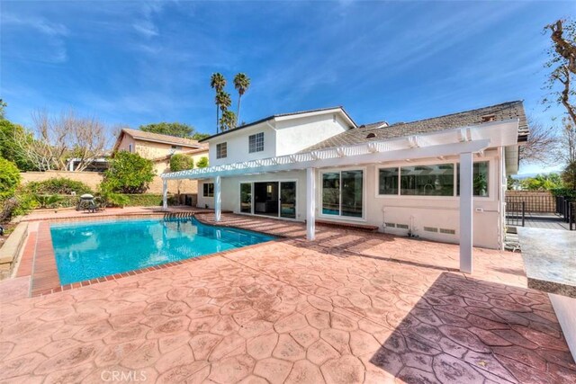 view of swimming pool featuring a fenced in pool, a patio area, fence, and a pergola