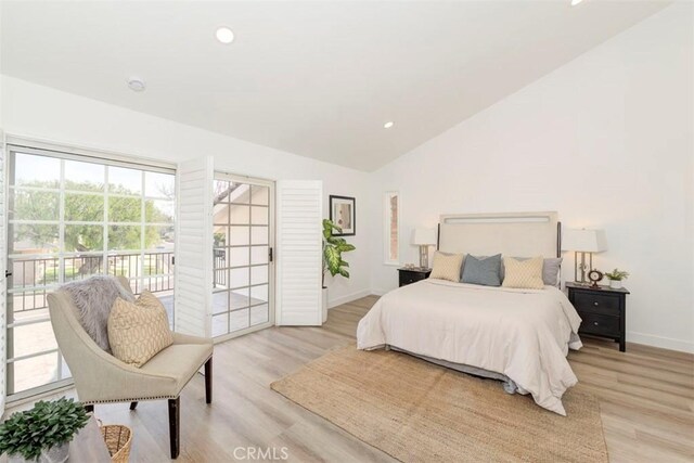 bedroom featuring light wood-style floors, access to outside, vaulted ceiling, and baseboards