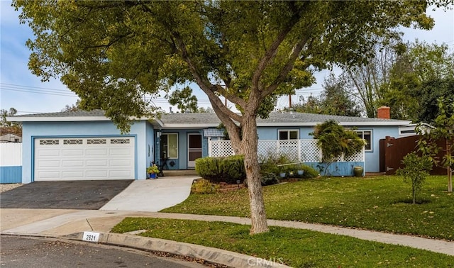 ranch-style home featuring a front lawn and a garage