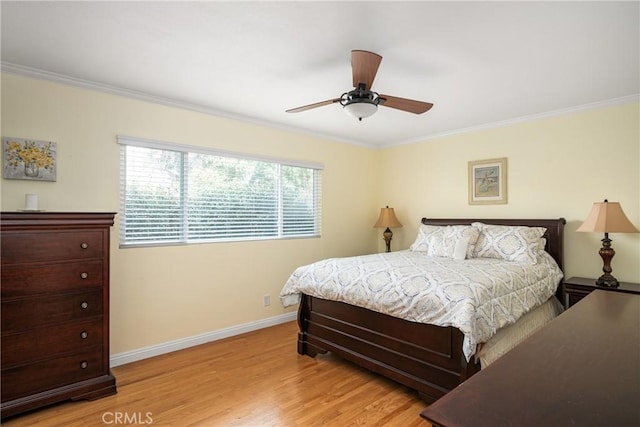 bedroom featuring ceiling fan, ornamental molding, and light hardwood / wood-style floors