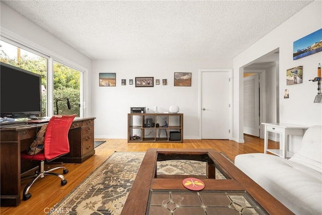 office space with a textured ceiling and hardwood / wood-style floors