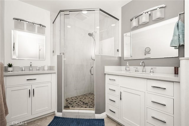 bathroom with a shower with door and vanity