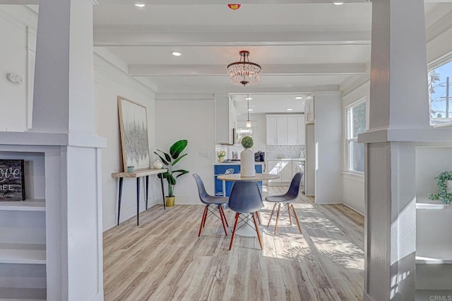 dining room featuring beam ceiling and light hardwood / wood-style floors