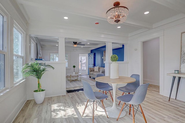 dining space featuring beam ceiling, light hardwood / wood-style flooring, and ceiling fan with notable chandelier