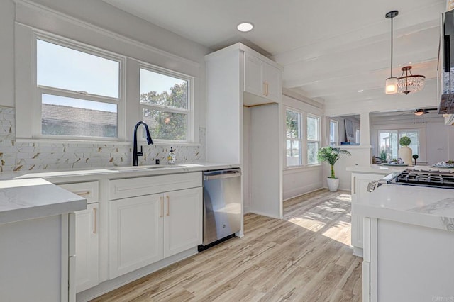 kitchen with white cabinetry, light hardwood / wood-style flooring, decorative light fixtures, plenty of natural light, and appliances with stainless steel finishes