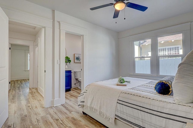 bedroom with ceiling fan, light hardwood / wood-style flooring, and ensuite bath