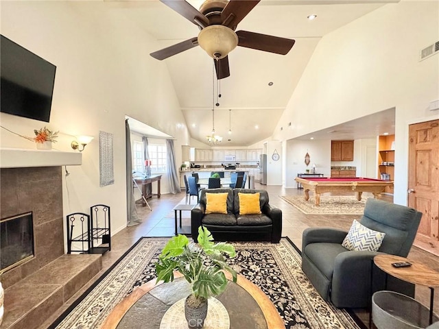 tiled living room featuring a fireplace, high vaulted ceiling, pool table, and ceiling fan