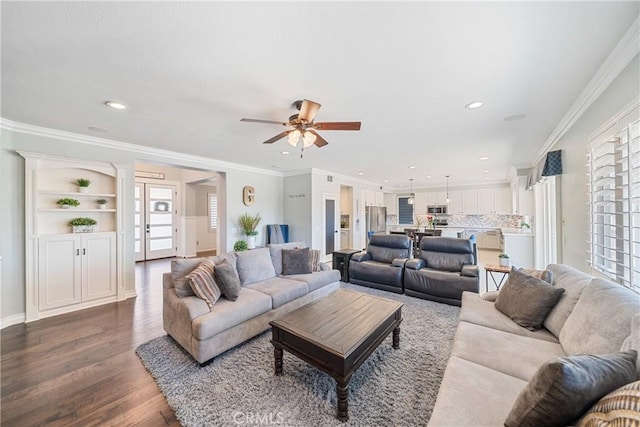 living area with ornamental molding, wood finished floors, and recessed lighting