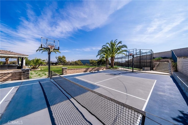 view of sport court featuring stairs, community basketball court, fence, and a gazebo