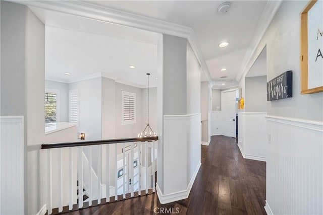 hall with wainscoting, ornamental molding, wood finished floors, a chandelier, and recessed lighting