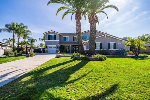 view of front of home with a front yard, driveway, an attached garage, and stucco siding