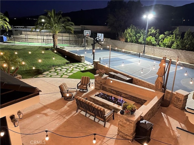 view of basketball court with a tennis court, community basketball court, and fence