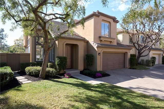 mediterranean / spanish house with stucco siding, an attached garage, a front yard, fence, and driveway