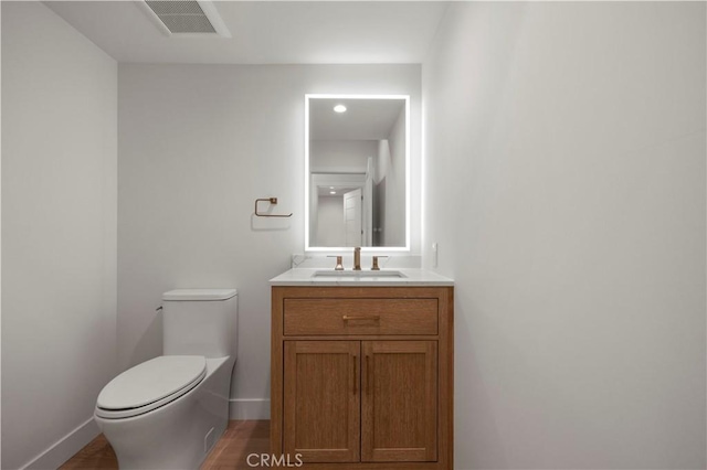 bathroom with toilet and vanity