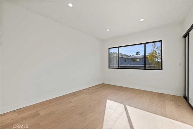 unfurnished room with hardwood / wood-style floors