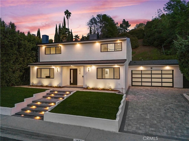 contemporary house with a garage and a lawn