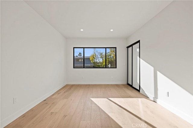 spare room with light hardwood / wood-style floors