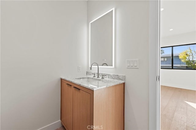 bathroom with vanity and hardwood / wood-style floors