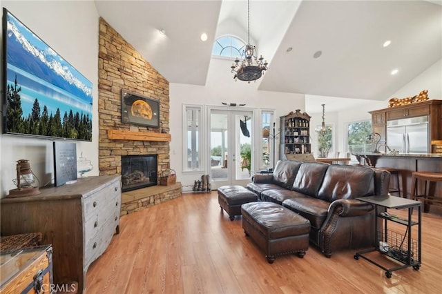 4210 Crestview Dr, Norco, CA 92860 - living area featuring high vaulted ceiling, a chandelier, a stone fireplace, and light wood finished floors