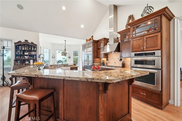4210 Crestview Dr, Norco, CA 92860 - kitchen featuring stainless steel appliances, glass insert cabinets, light wood-type flooring, a kitchen breakfast bar, and a spacious island