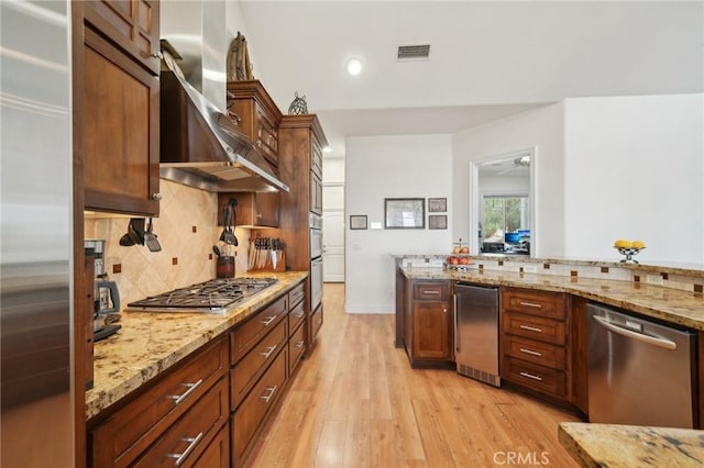 4210 Crestview Dr, Norco, CA 92860 - kitchen with appliances with stainless steel finishes, wall chimney exhaust hood, light wood-type flooring, tasteful backsplash, and light stone countertops