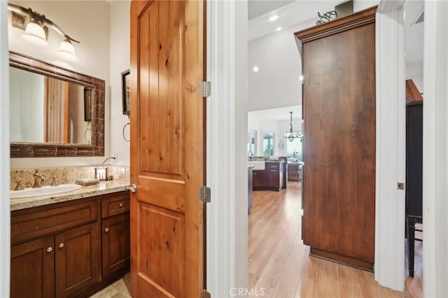 4210 Crestview Dr, Norco, CA 92860 - bathroom with vanity, wood finished floors, and a chandelier