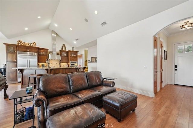 4210 Crestview Dr, Norco, CA 92860 - living room with arched walkways, light wood-style flooring, crown molding, recessed lighting, and high vaulted ceiling