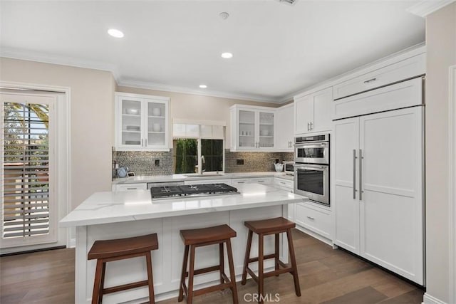 kitchen featuring white cabinetry, glass insert cabinets, and a center island