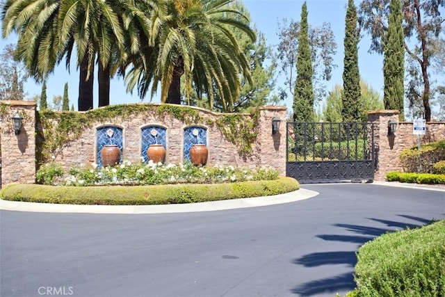 community sign featuring a gate